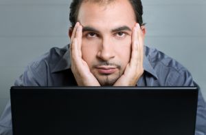man upset about web design at computer