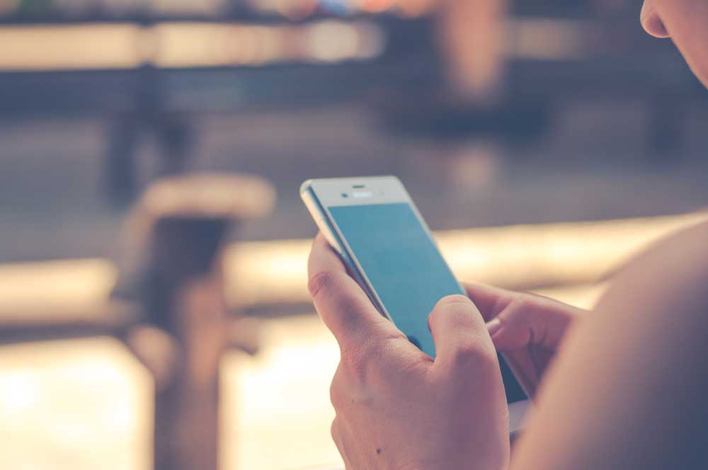 websites provide better user experience with mobile web design image shows pair of hands holding cell phone