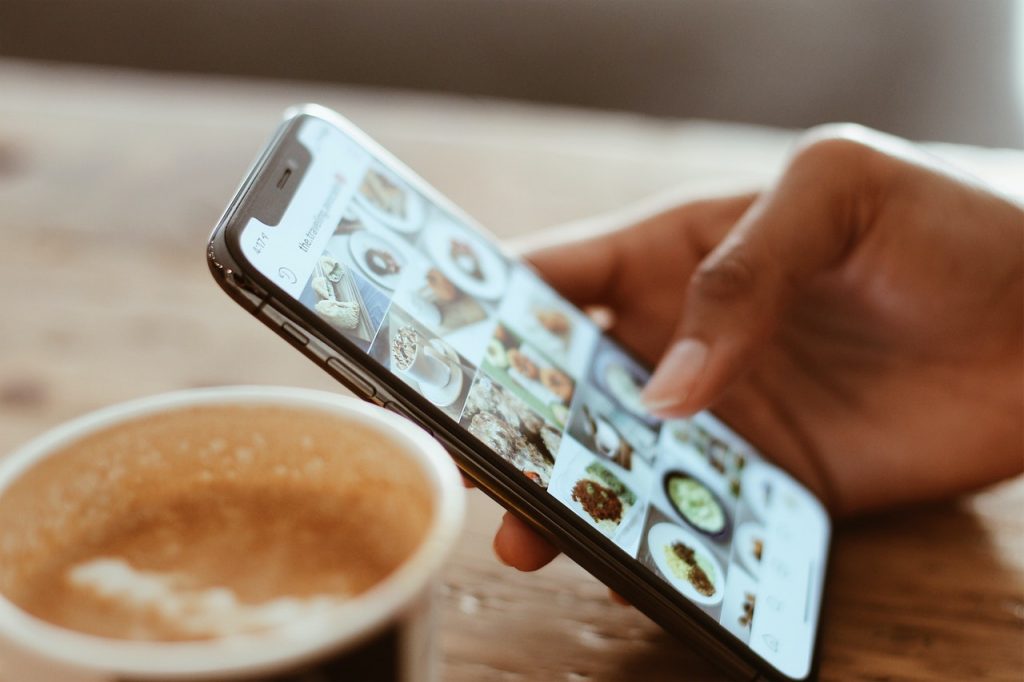 mobile web design helps mobile device users image shows hand scrolling through cell phone images